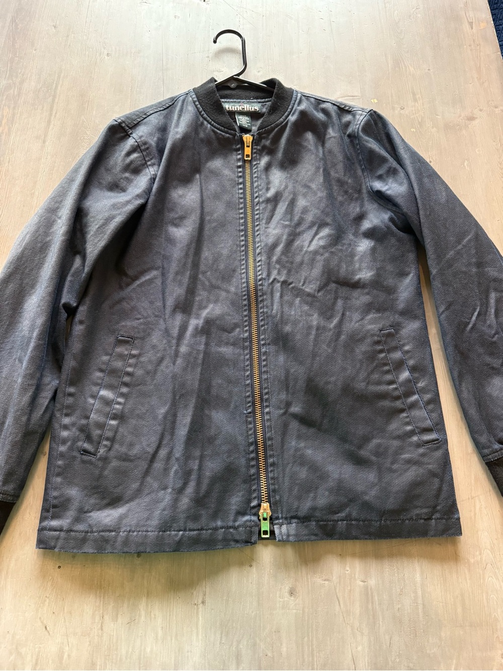 Tunnelus bomber jacket made of navy blue coated denim with a gold full zip
